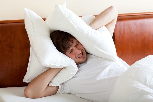 http://www.dreamstime.com/royalty-free-stock-photos-man-can-t-sleep-noise-covering-ears-pillows-image36992988